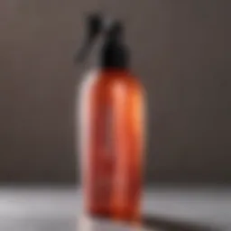 Close-up of a spray bottle with a lustrous glow, representing a heat protectant product designed for dry hair.