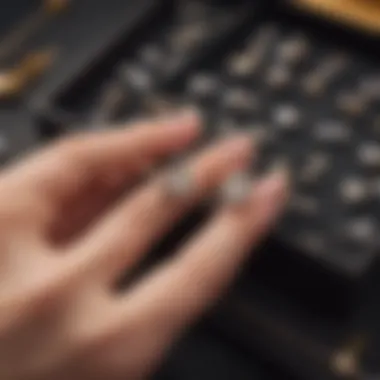 A close-up of a hand selecting stud earrings from a jewelry box