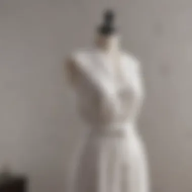 Elegant sleeveless white linen dress displayed on a mannequin.