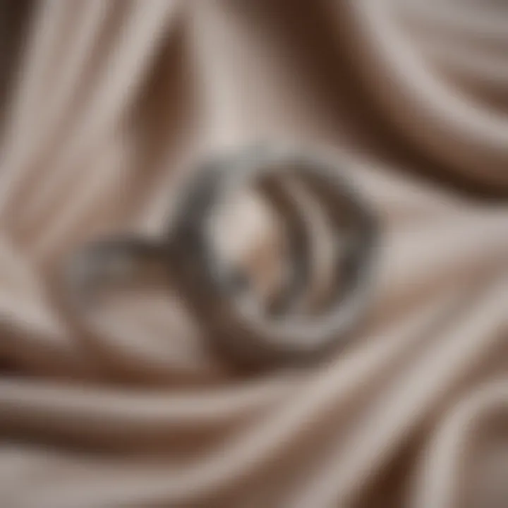 Two intertwined rings resting on a soft fabric