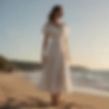 The elegant silhouette of the Staud Seashore Dress showcased against a serene beach backdrop.