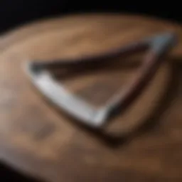 A vintage straight razor on a wooden surface