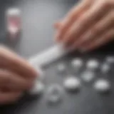 A close-up view of essential tools for acrylic nail removal, including acetone, cotton balls, and a nail file.