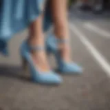 Elegant pair of light blue suede shoes on a summer street.