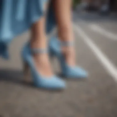 Elegant pair of light blue suede shoes on a summer street.