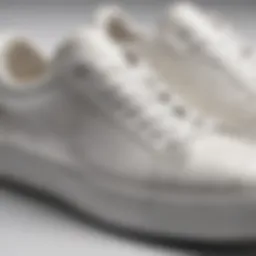 Close-up of a pair of sleek slim white leather sneakers highlighting the texture and craftsmanship.